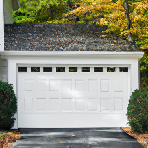 Suburban Lexington home exterior with a closed white residential garage door, driveway, and autumn trees.