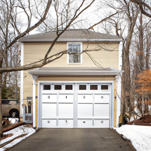 Modern steel garage door on a colonial Lexington, MA home with light snow on the driveway and yard.